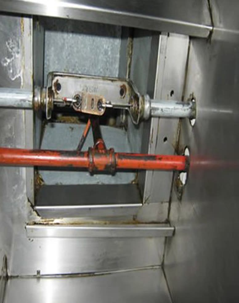 The same hood interior after cleaning, bare stainless steel