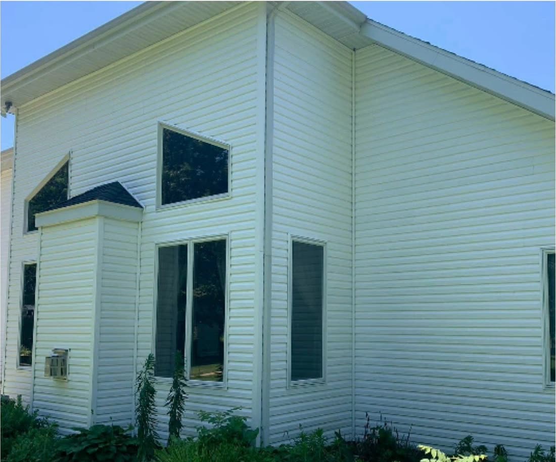 The same house exterior after washing, bright and clean