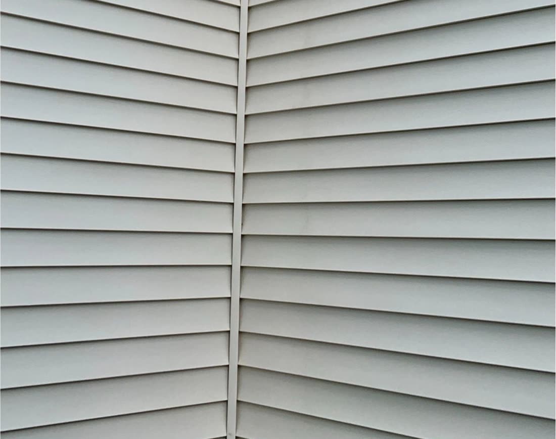 The same siding after soft washing, clean and even